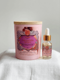 Pink aromatherapy candle with wooden lid and vibrant label featuring botanical illustrations, promoting focus and energy